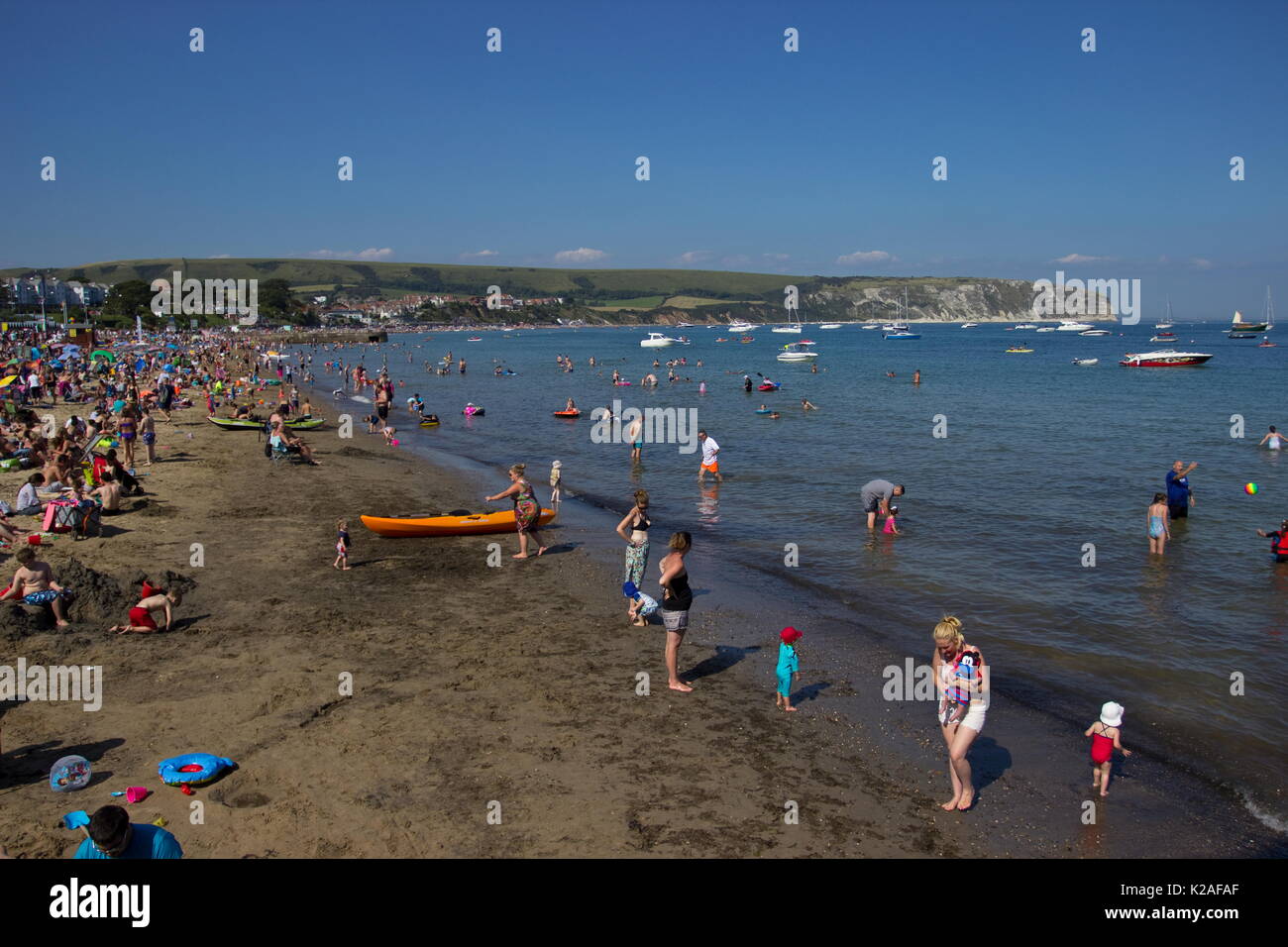 Holiday makers enjoying the Beach Swanage Dorset Stock Photo Alamy