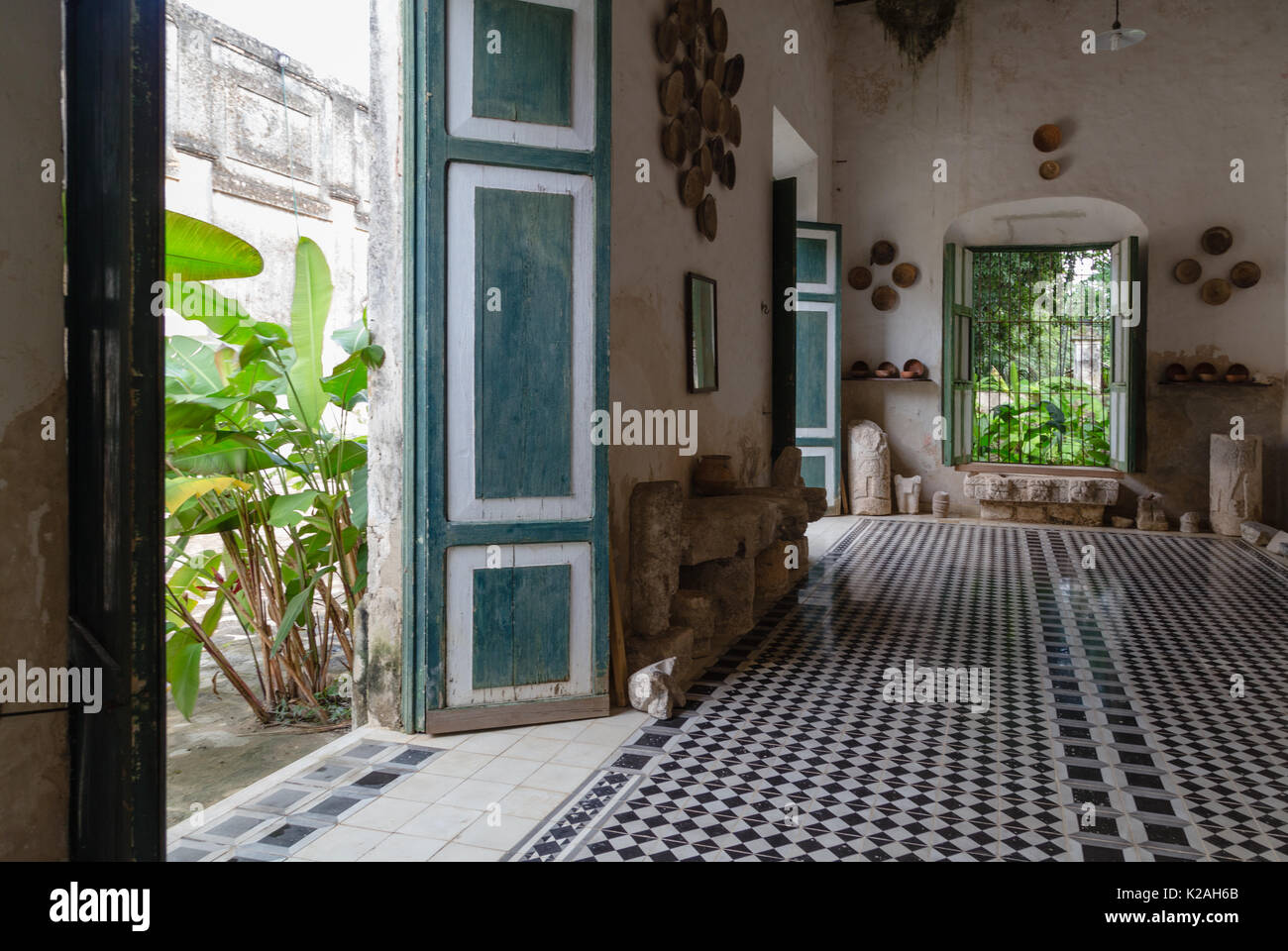 One of the rooms decorated with pottery and tile floor is with Black and white geometric tiles at Hacienda Yaxcopoil, Yaxcopoil, Yucatan, Mexico. Stock Photo