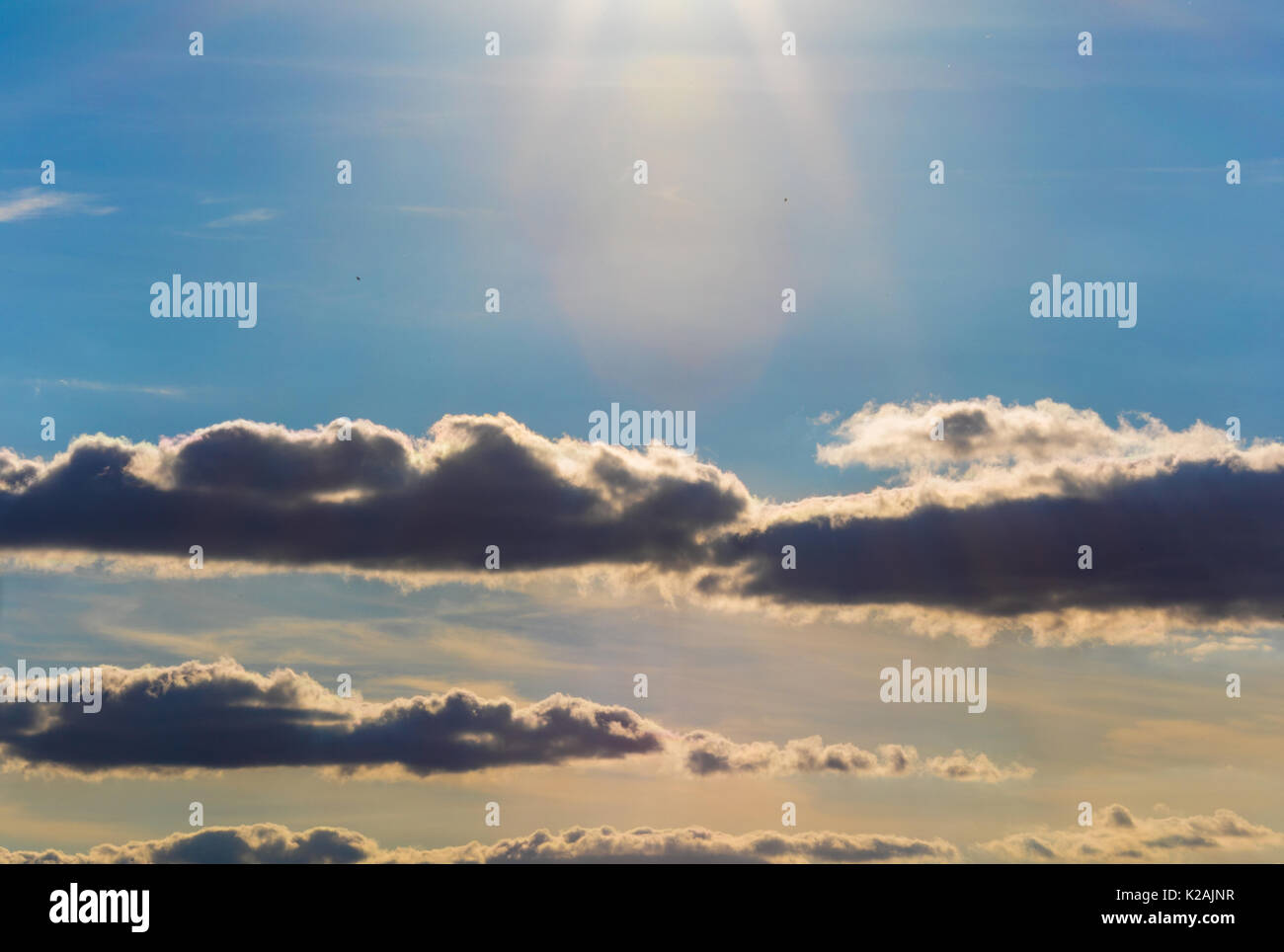 Beautiful blue sky with clouds and sun before sunset Stock Photo - Alamy