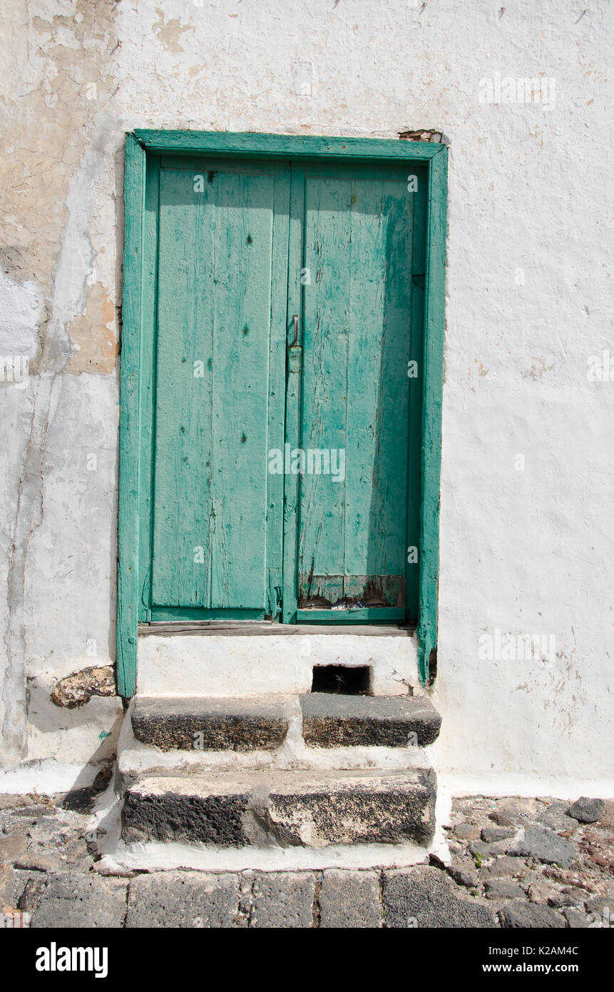 Old green wooden door in a building in Lanzarote Stock Photo
