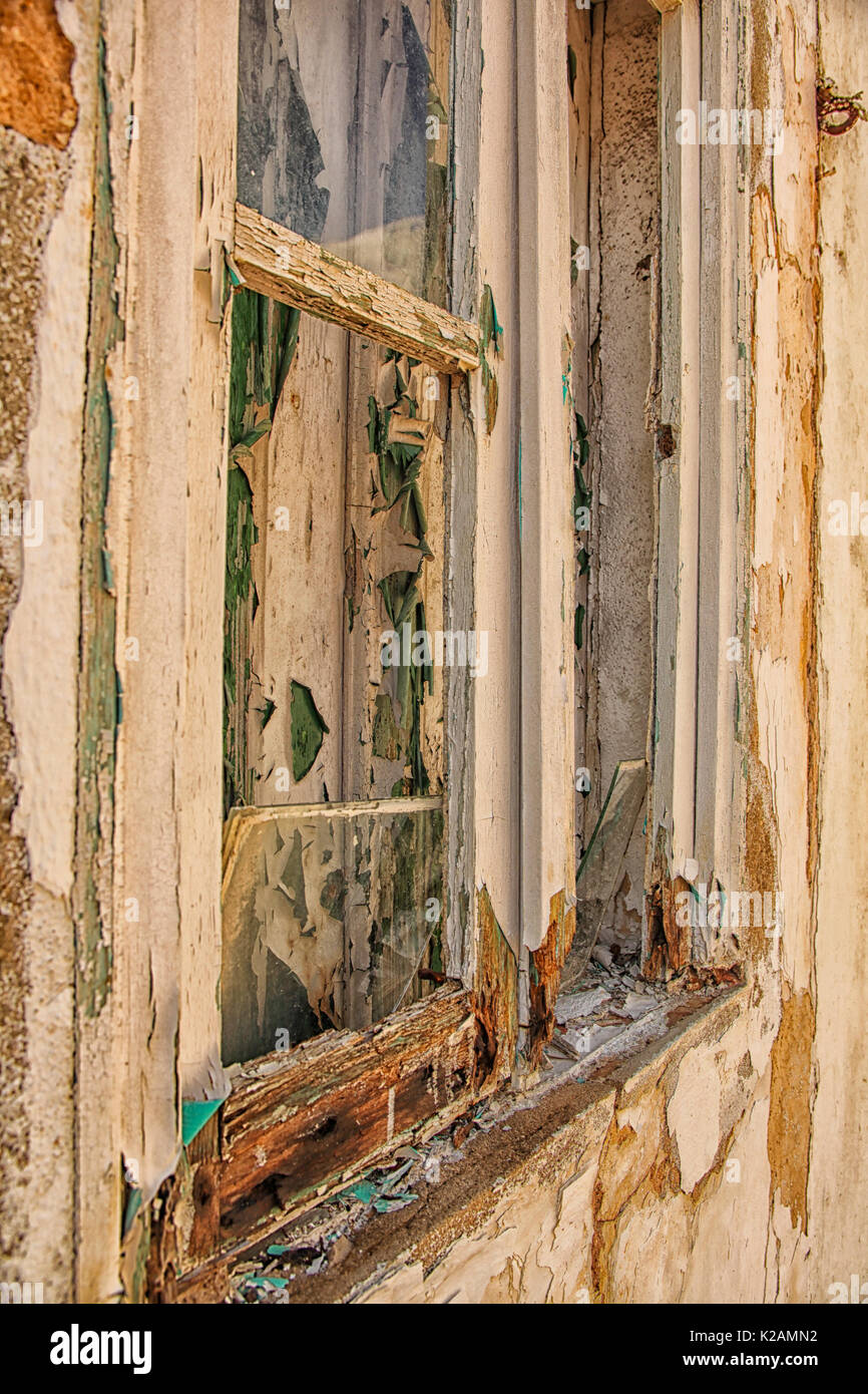 A pair of worn closed windows  with chipped paint and weathered panels. Stock Photo