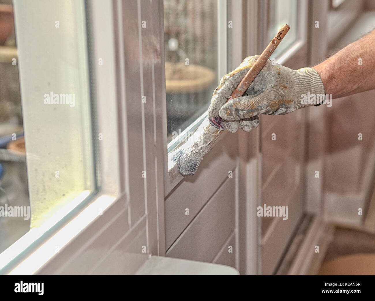 Hand with paintbrush painting a door white Stock Photo Alamy