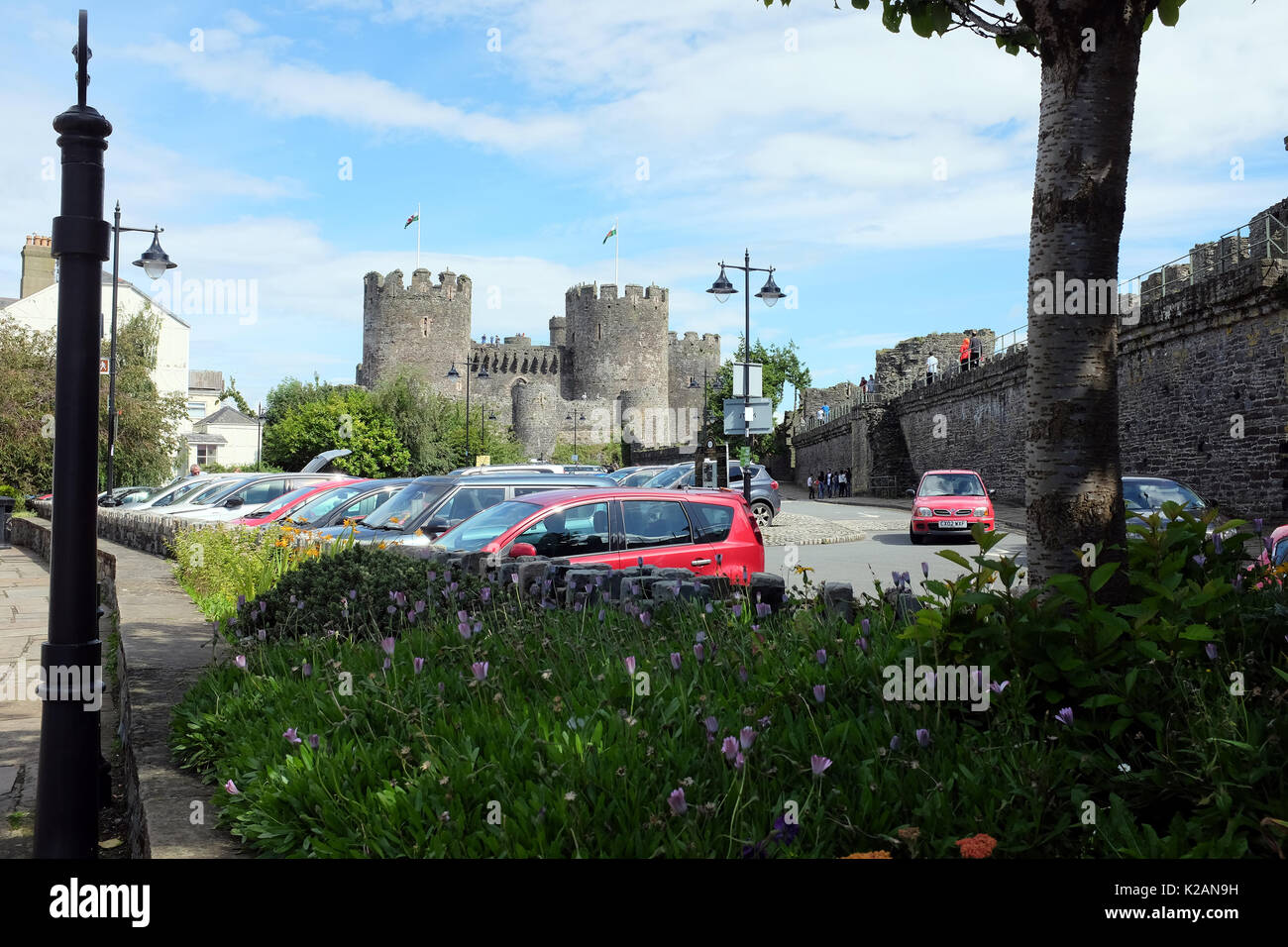 Conwy, Wales, UK. July 31, 2017. Conwy castle from inside the town wall with tourists walking the walls at Conwy in Wales. Stock Photo