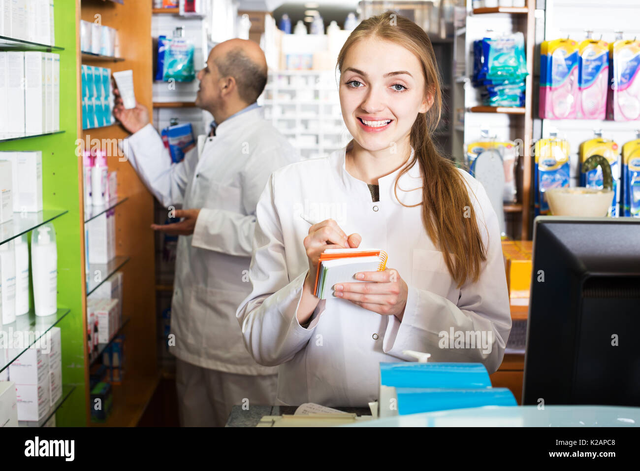 Professional team of pharmaceutist and technician working in chemist shop Stock Photo