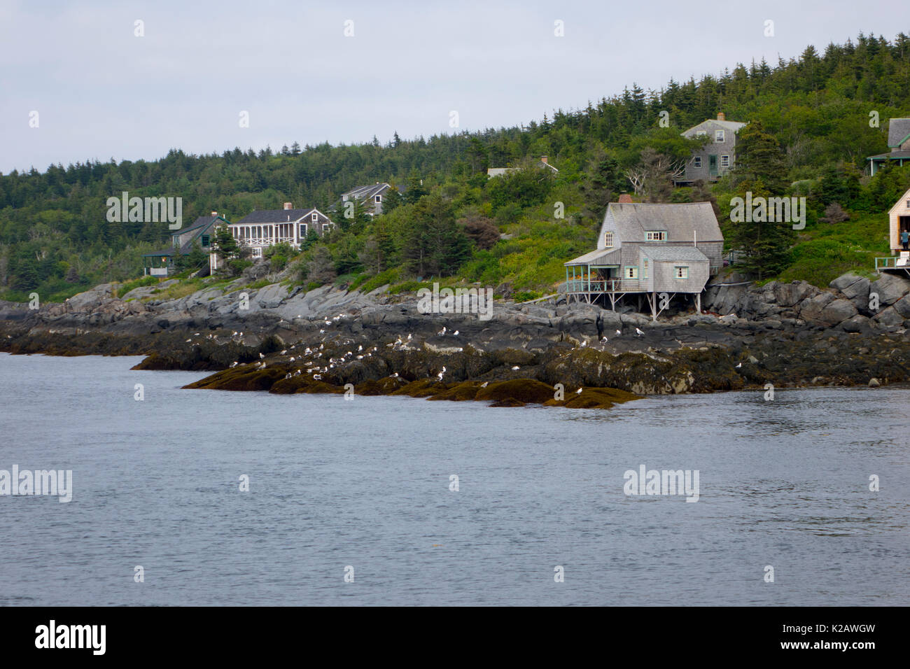 USA Maine ME Monhegan Island homes and cottages dot the shoreline Stock