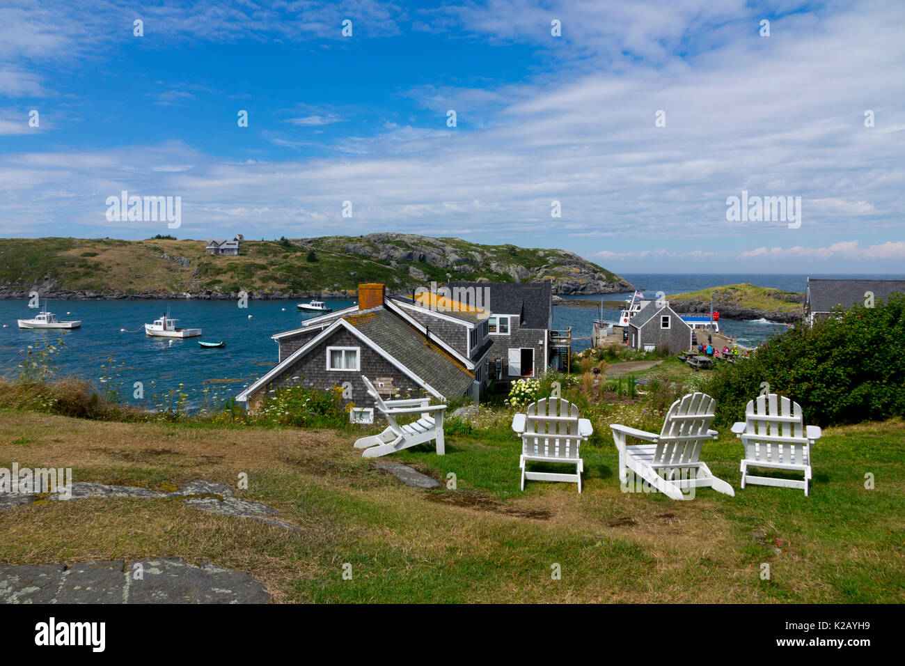 USA Maine ME Monhegan Island in Penobscot Bay in the Atlantic Ocean Adirondack chairs on a lawn Stock Photo