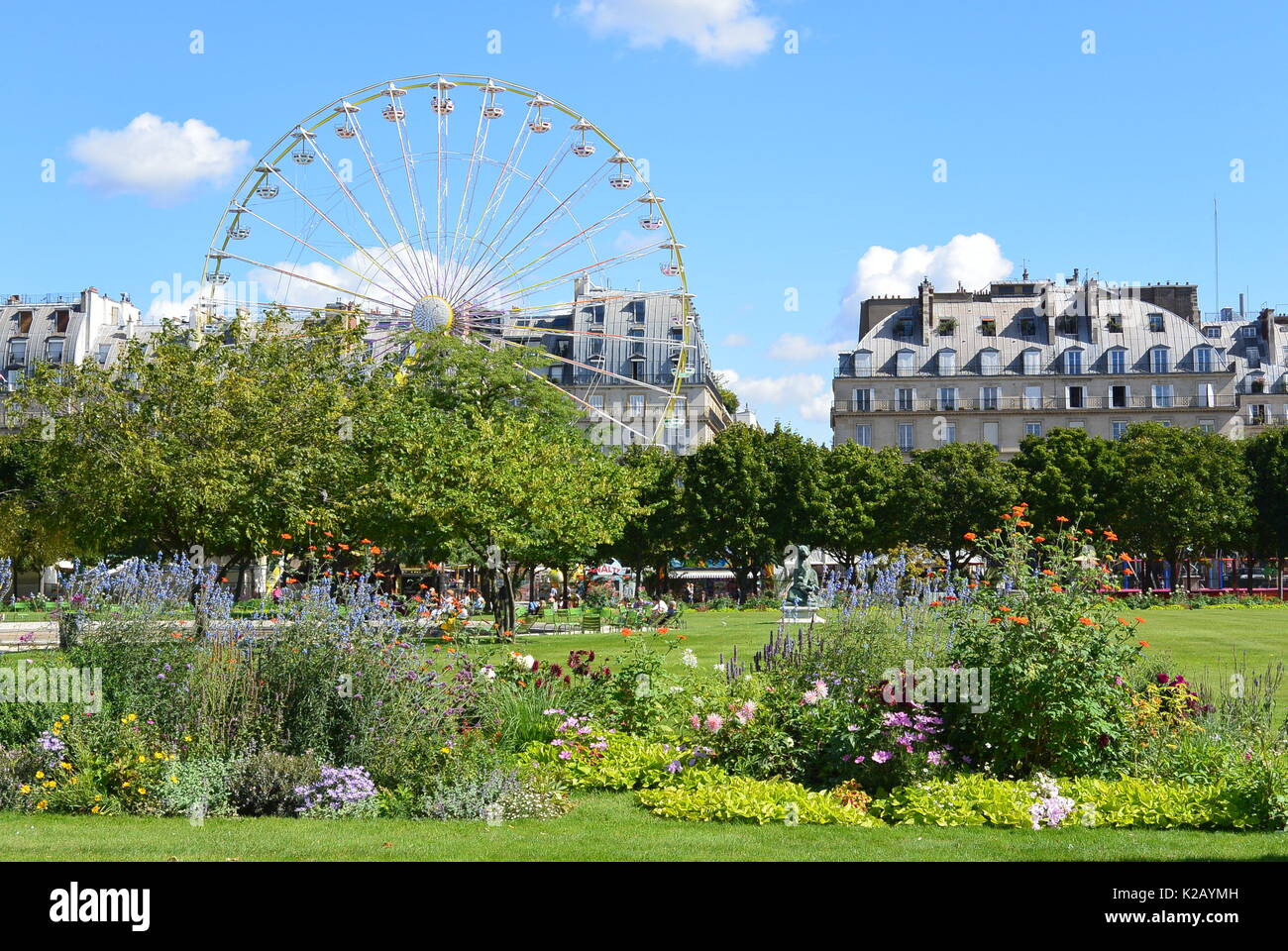 sunny summer day in the Tuileries Garden full of green nature and colourful flowers with great panorama and blue sky Stock Photo
