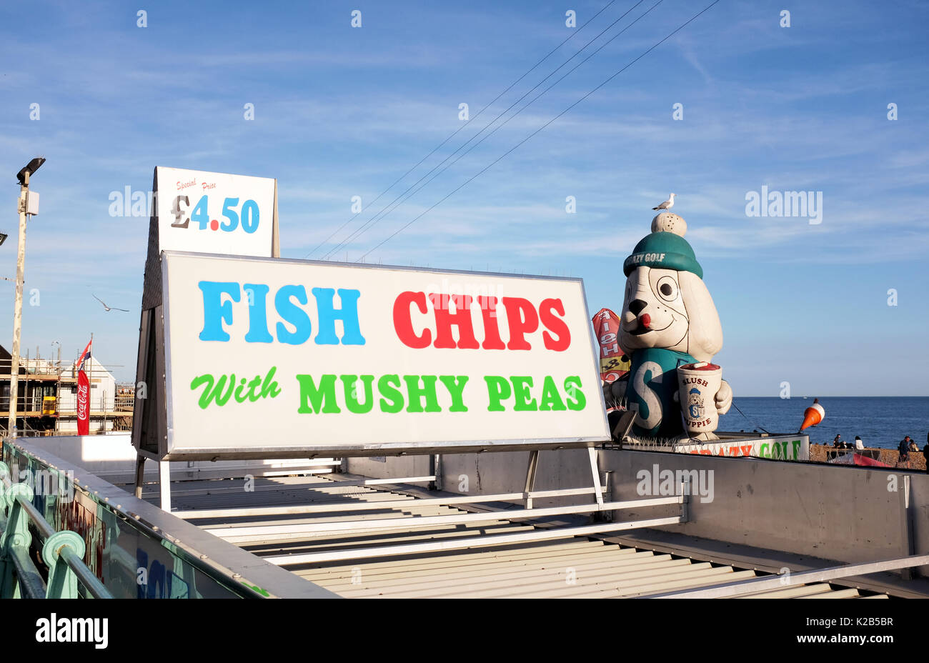 Brighton seafront summer views in August 2017 - Famous Fish & Chips Mushy Peas sign with giant Slush Puppie Stock Photo
