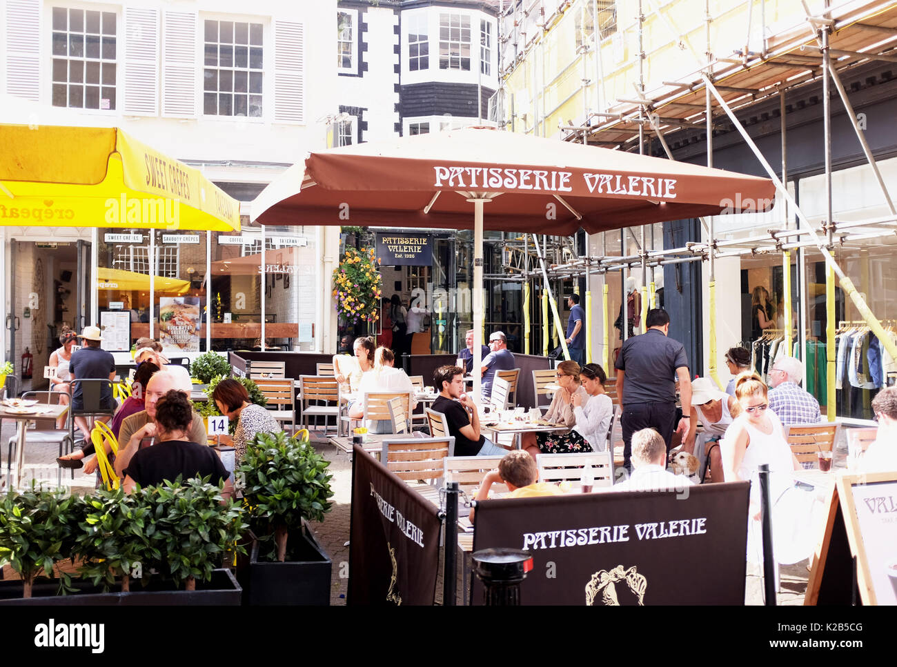 Brighton summer views in August 2017 - Patisserie Valerie coffee shop and cafe with people eating and drinking outside in The Lanes district Stock Photo