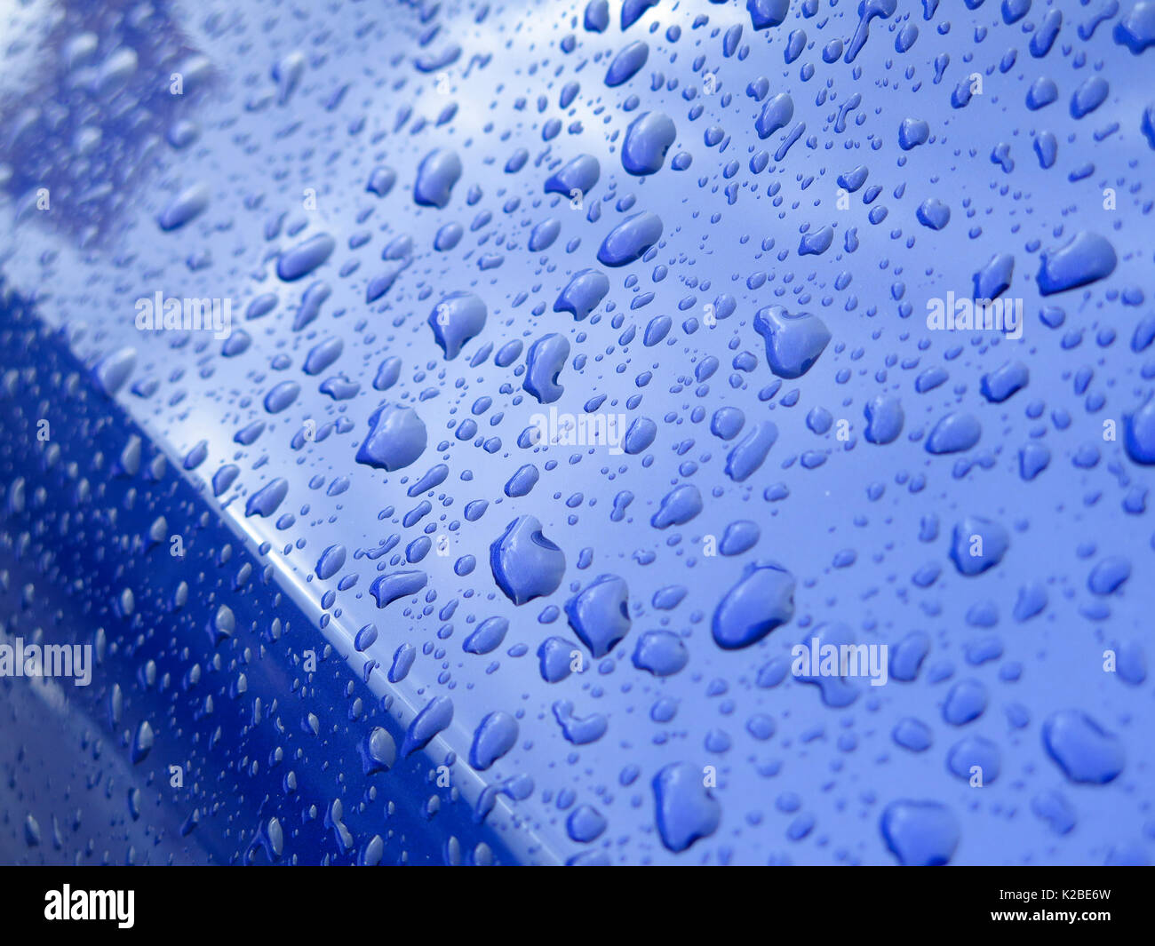 Raindrops on blue car Stock Photo