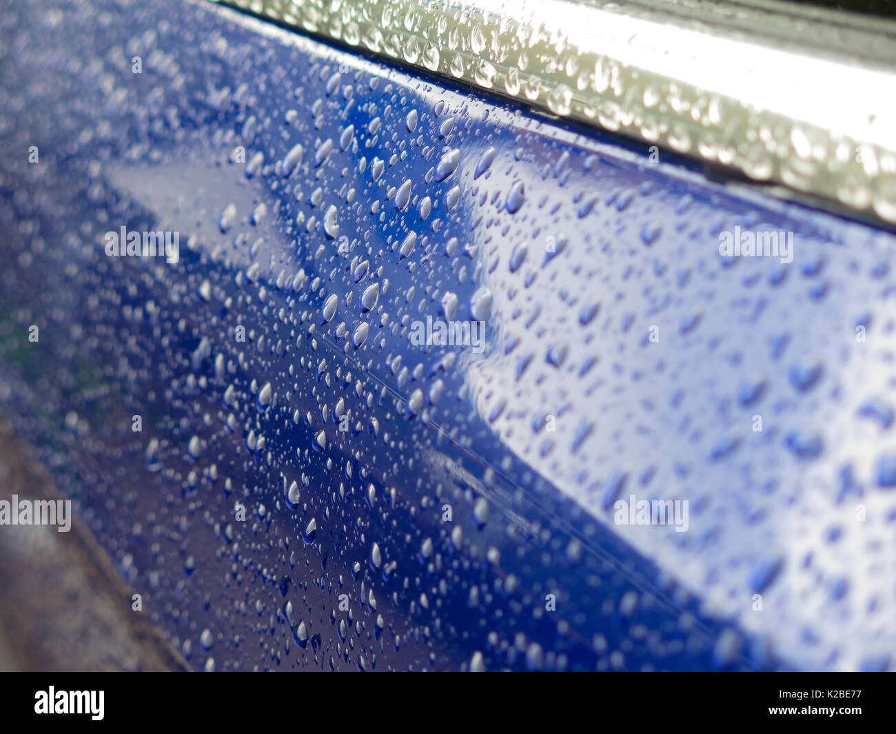 Raindrops on blue car Stock Photo