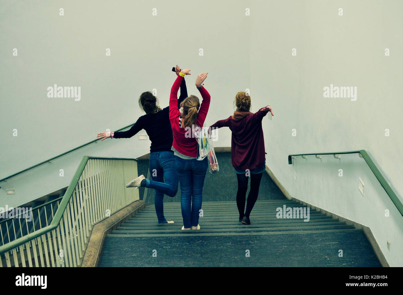 Three girls going down a staircase Stock Photo