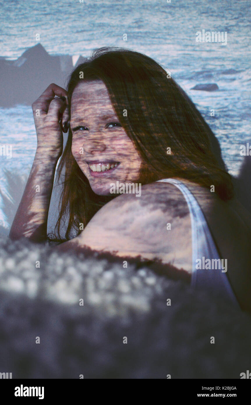 Girl in front of projected landscape Stock Photo