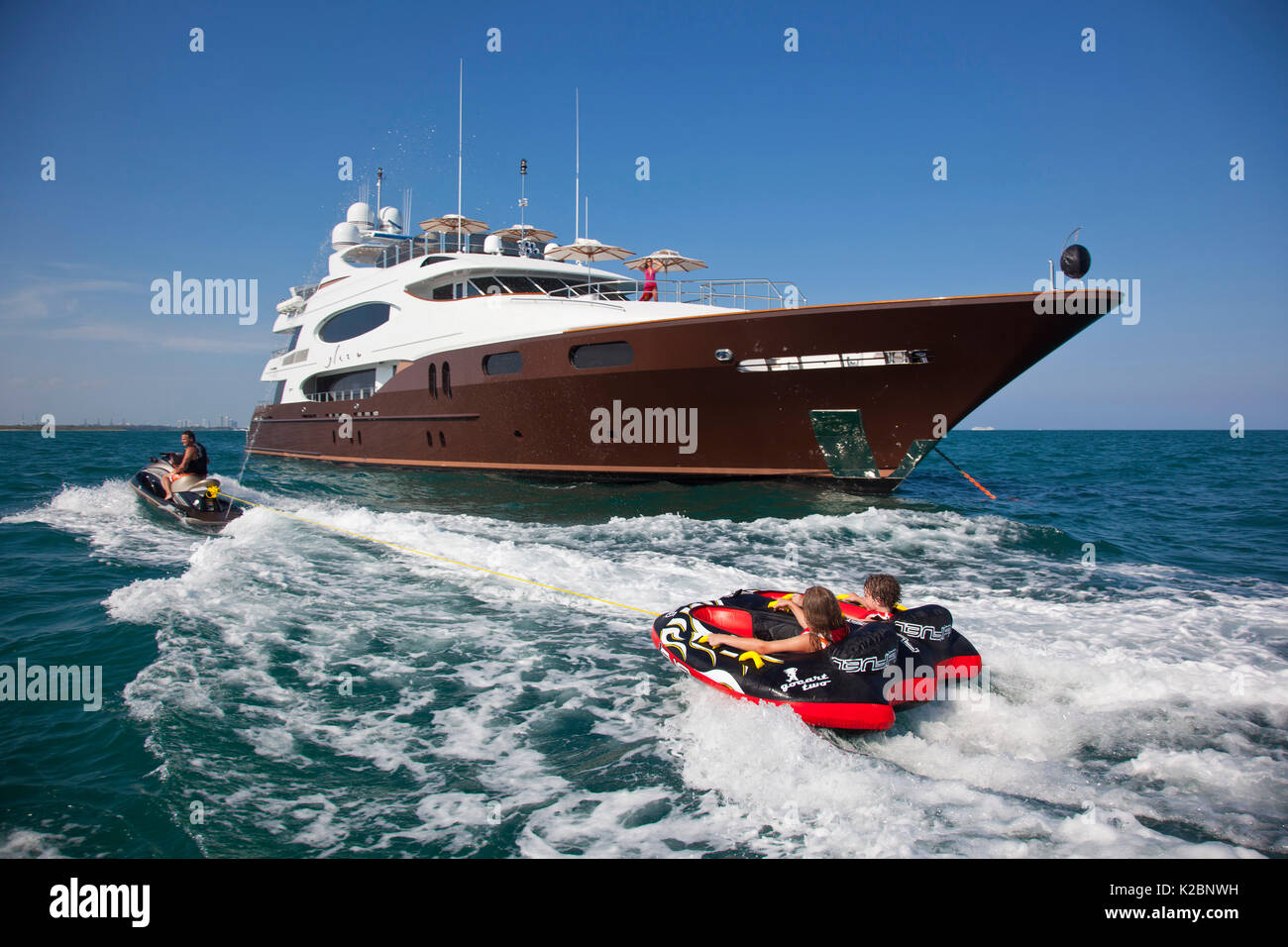 Children water tubing near yacht Glaze 161foot Trinity, Miami, Florida