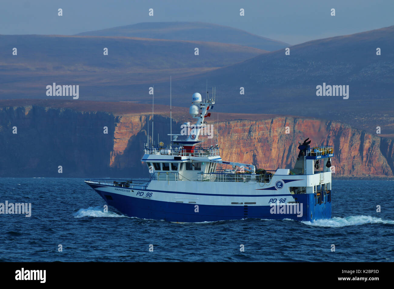 Fishing vessel 'Harvester' heading north on west side of Orkney Islands, Scotland, March 2015. Property released. Stock Photo