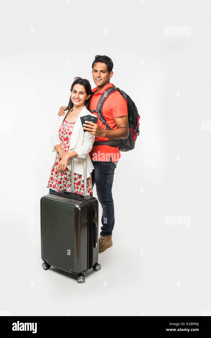 stock photo of smart Asian or Indian couple traveler with suitcase and ...