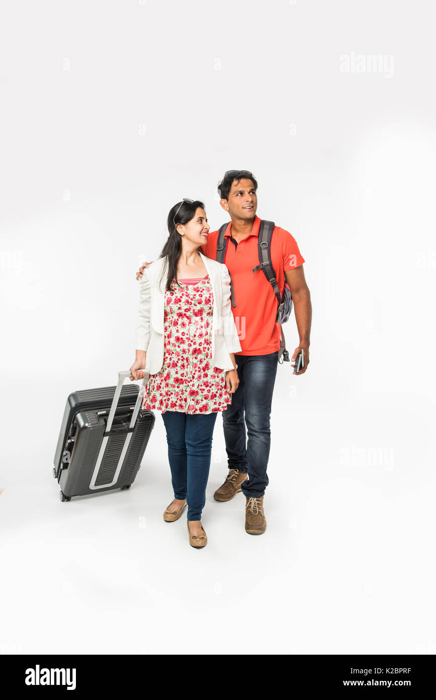 stock photo of smart Asian or Indian couple traveler with suitcase and ...