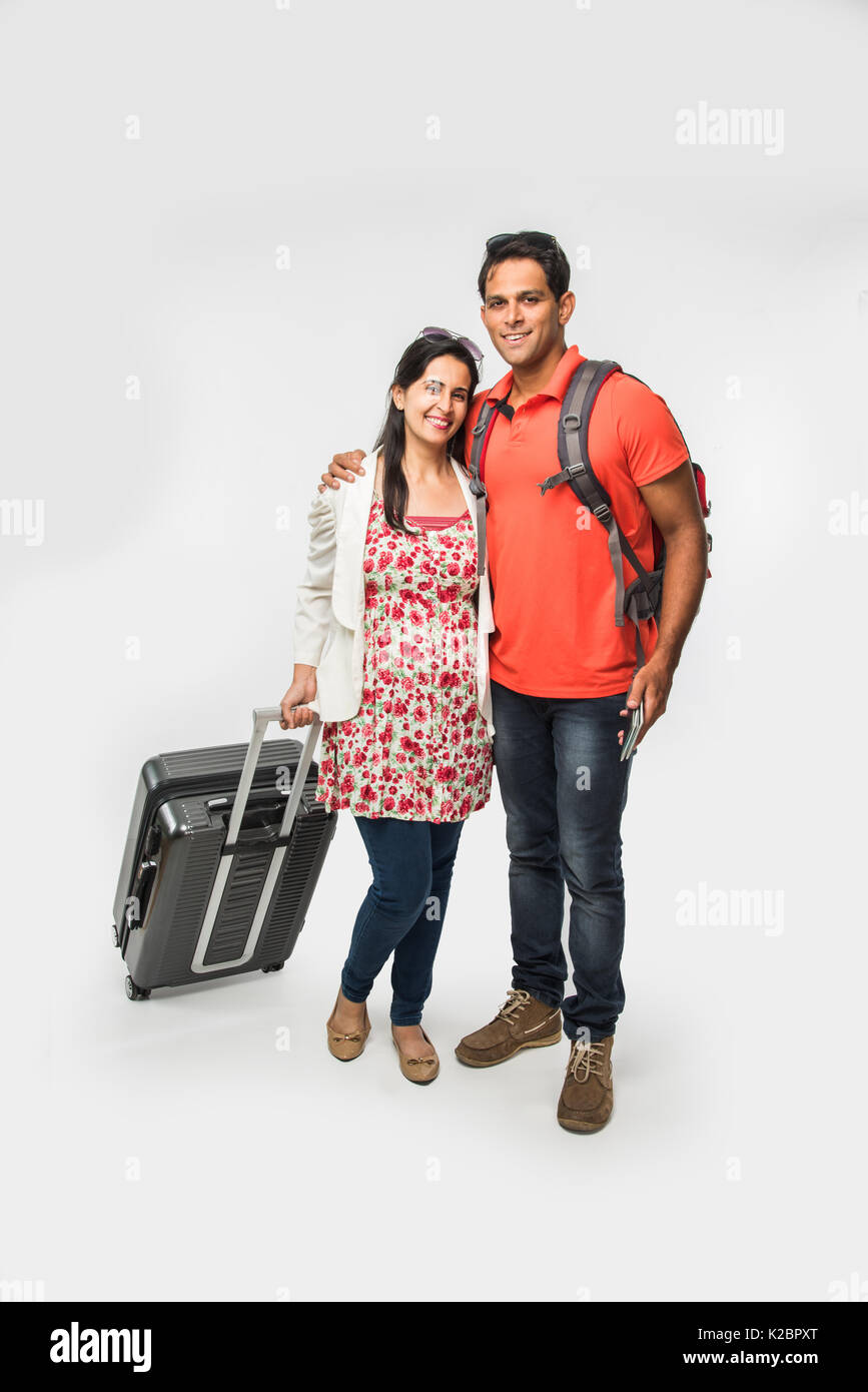stock photo of smart Asian or Indian couple traveler with suitcase and ...