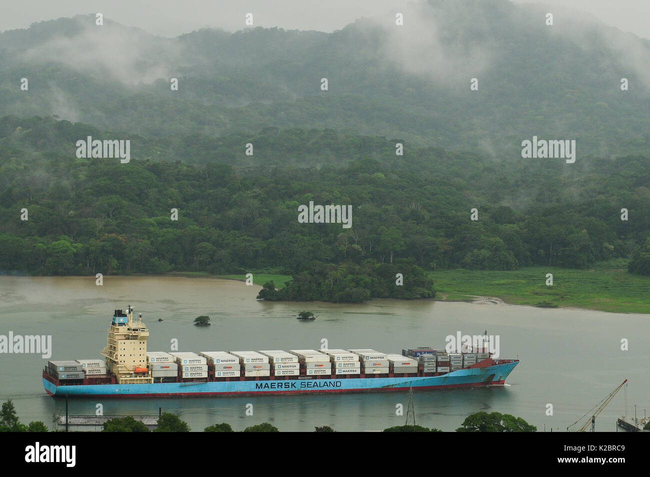 Container ship sailing through the Panama Canal. All non-editorial uses must be cleared individually. Stock Photo