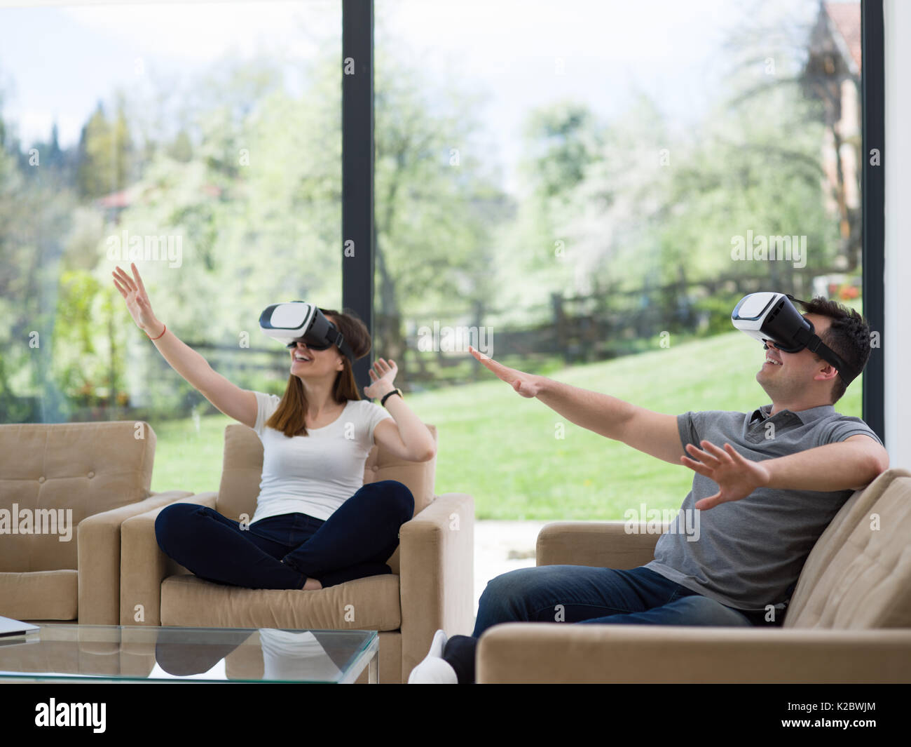 Couple using virtual reality headset in living room at home people ...