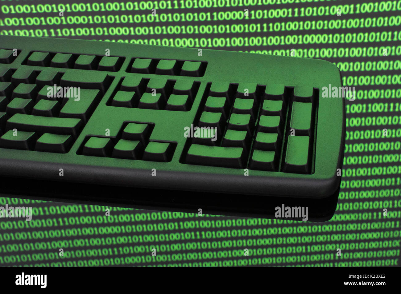 Black keyboard + binary code - for online transactions, cybercrime darkweb, hacking, cyberattack, data protection cyber-theft, 1s and 0s, hacktivism. Stock Photo