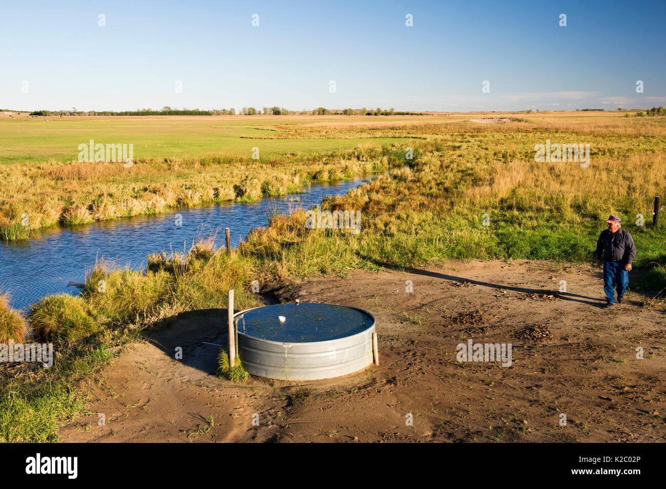 Lynn Ballagh inspecting water well on his cattle ranch in the Sandhills of Nebraska, Garfield County, Nebraska, USA. October 2014. Stock Photo