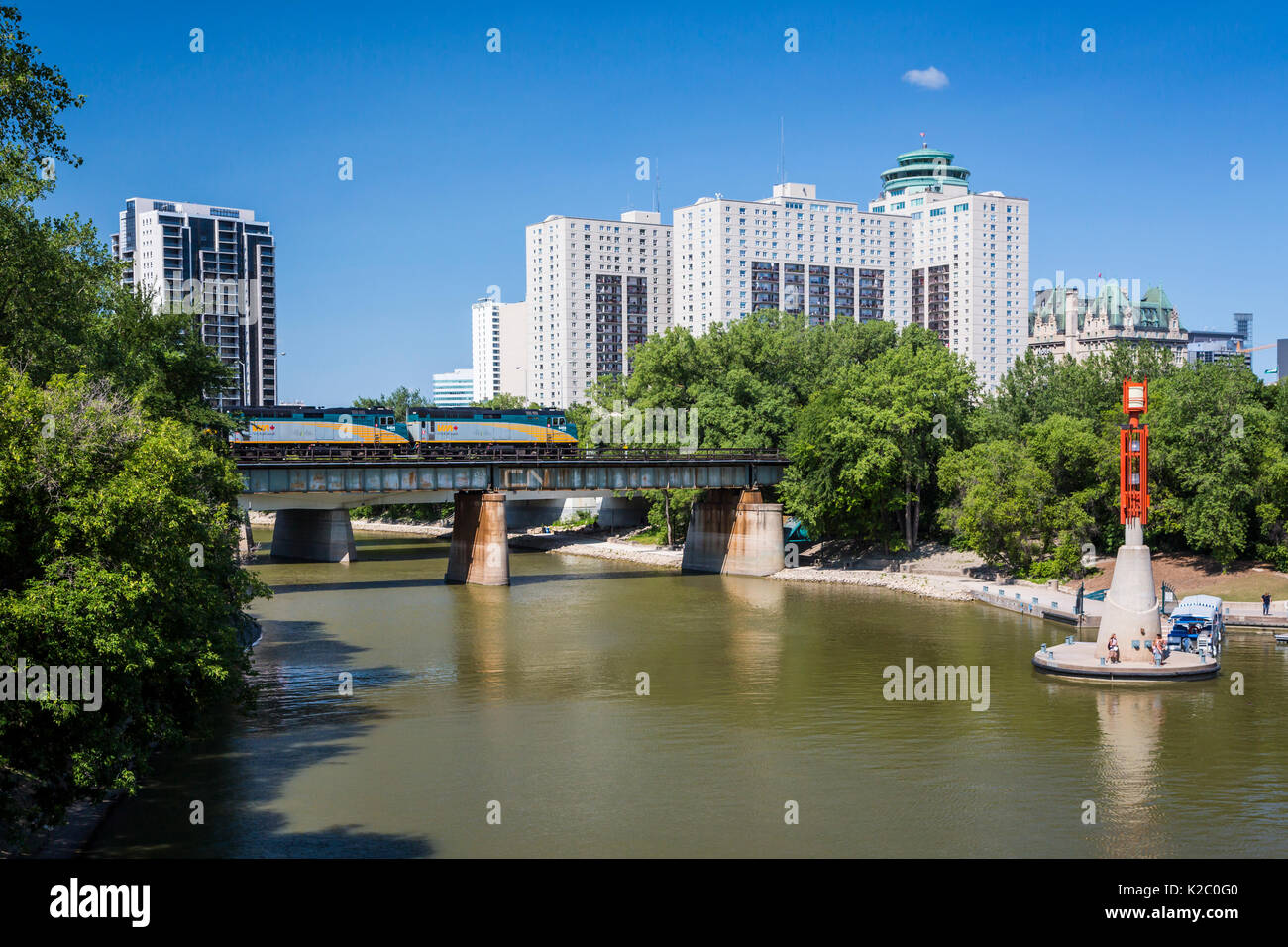 The Assiniboine River, a CN train at the Forks National Historic site ...