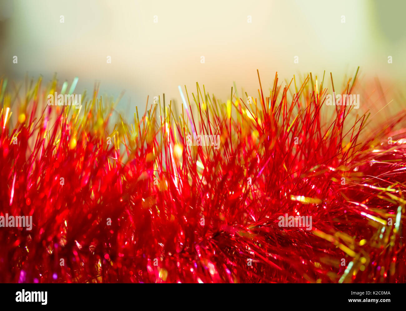 Christmas festive background of shiny Christmas tree tinsel. Selective focus. Blurred macro photo. The concept of Christmas and new year. Free space f Stock Photo