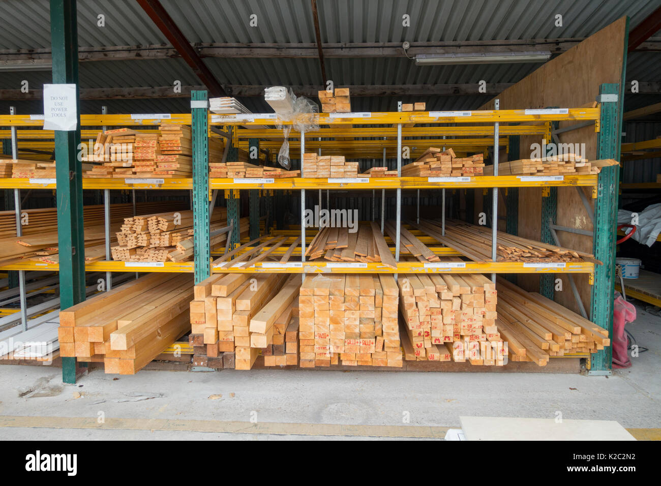 Stacked timber shelves at popular building trade merchants Travis Perkins outside under cover at Winsford Branch, Cheshire Stock Photo