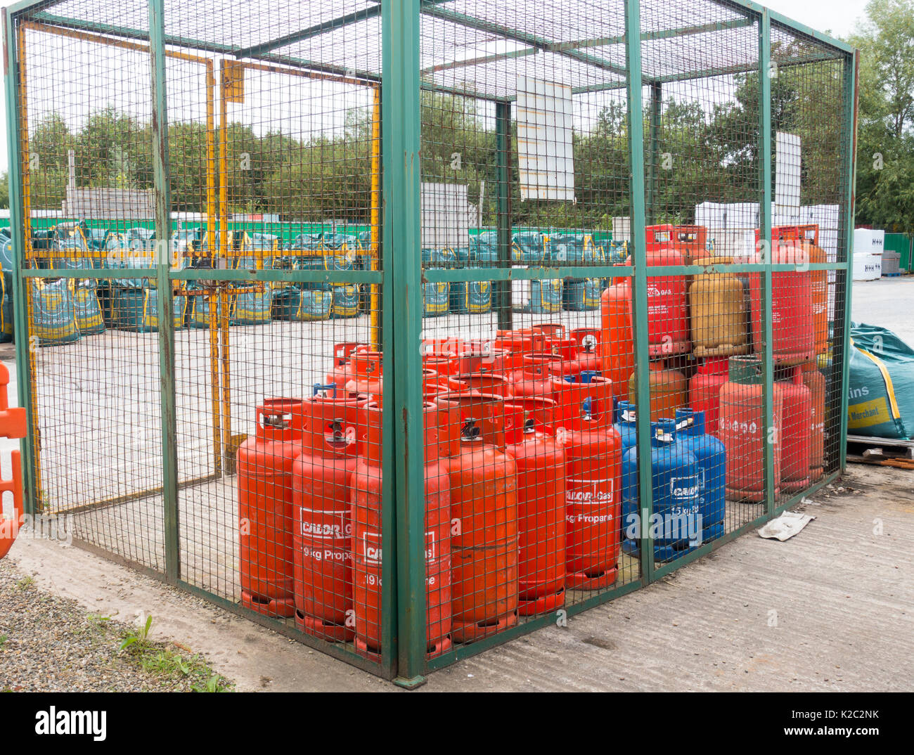 Gas bottles in a security cage on sale at the popular builders merchant Travis Perkins at the Winsford Site, Cheshire, UK Stock Photo