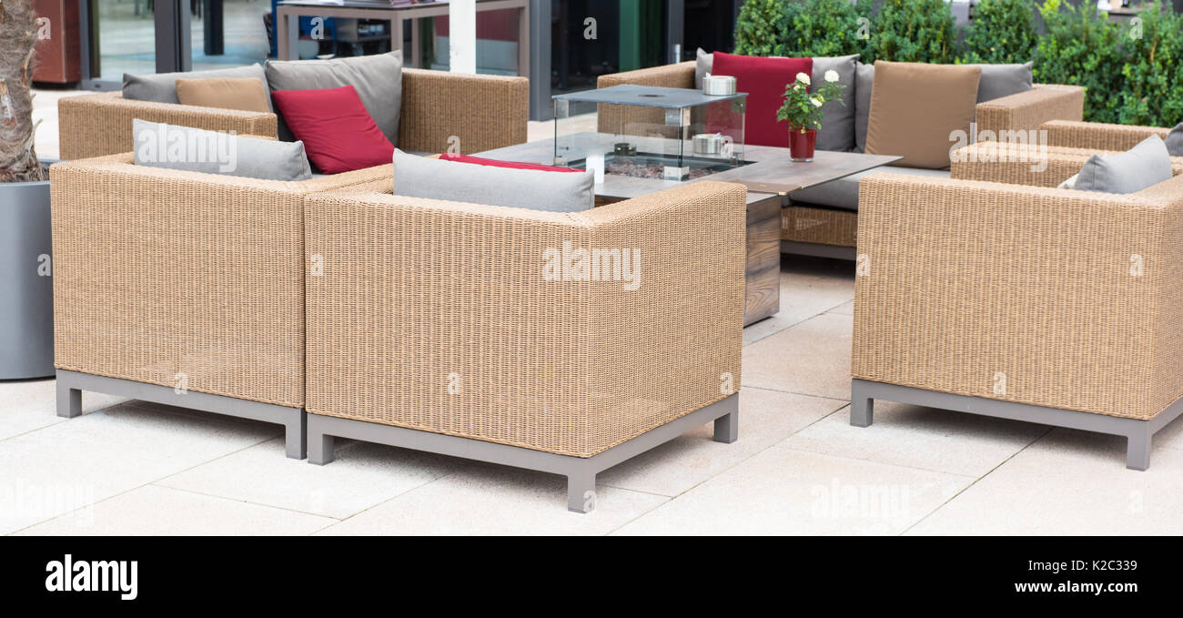 Lounge corner with couch, table and armchairs with colorful cushions ...