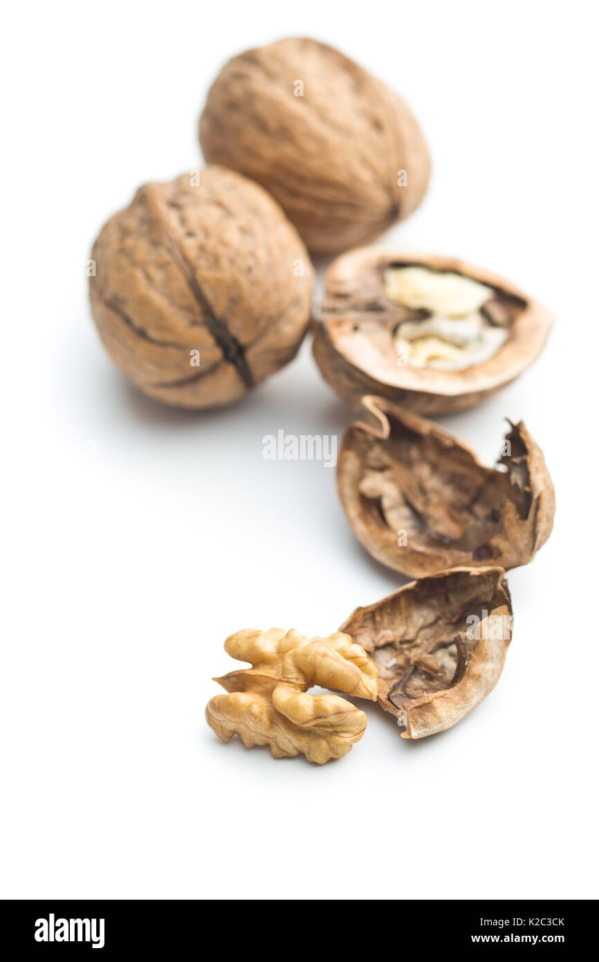 Cracked dried walnuts isolated on white background. Tasty nuts. Stock Photo