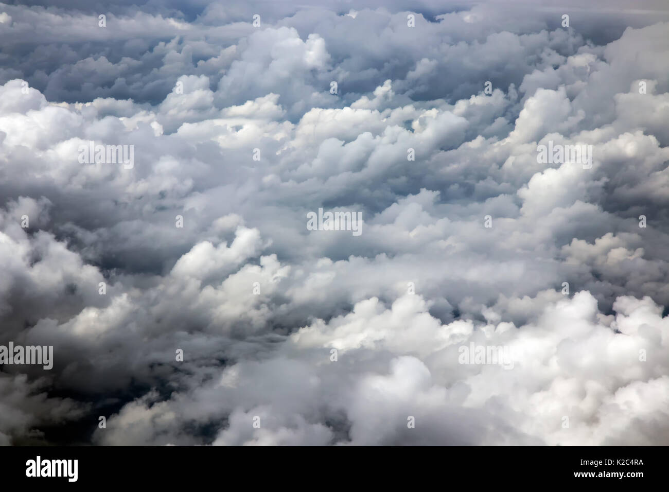 The dramatic sky with clouds made from a window of an airplane. Stock Photo