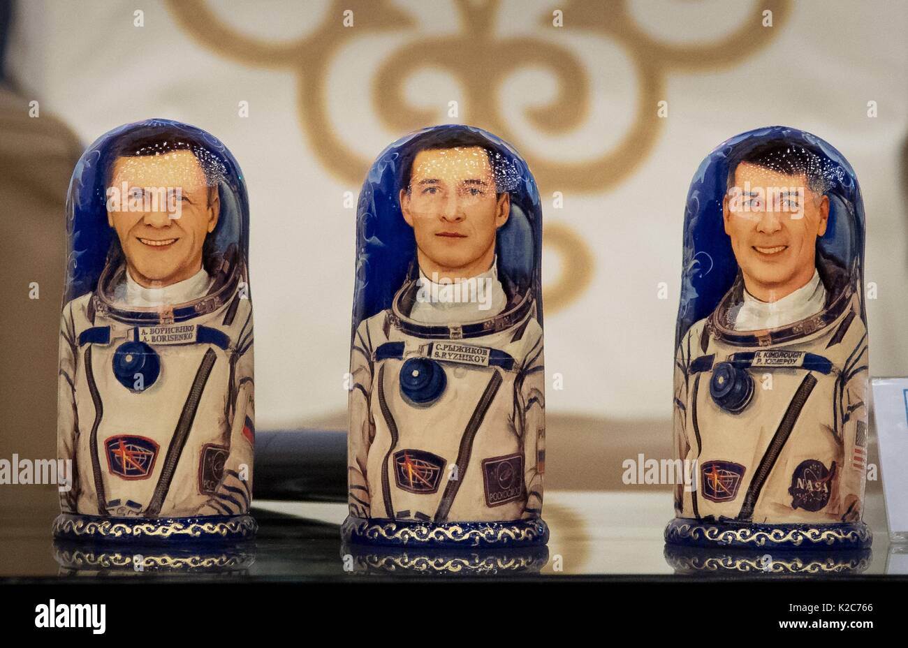 Hand-painted Russian matryoshka nesting dolls depicting NASA International Space Station Expedition 50 Soyuz MS-02 prime crew members (L-R) Russian cosmonauts Andrey Borisenko and Sergey Ryzhikov of Roscosmos, and American astronaut Shane Kimbrough are on display during a welcome ceremony at the Karaganda Airport April 10, 2017 in Karagandy, Kazakhstan. Stock Photo