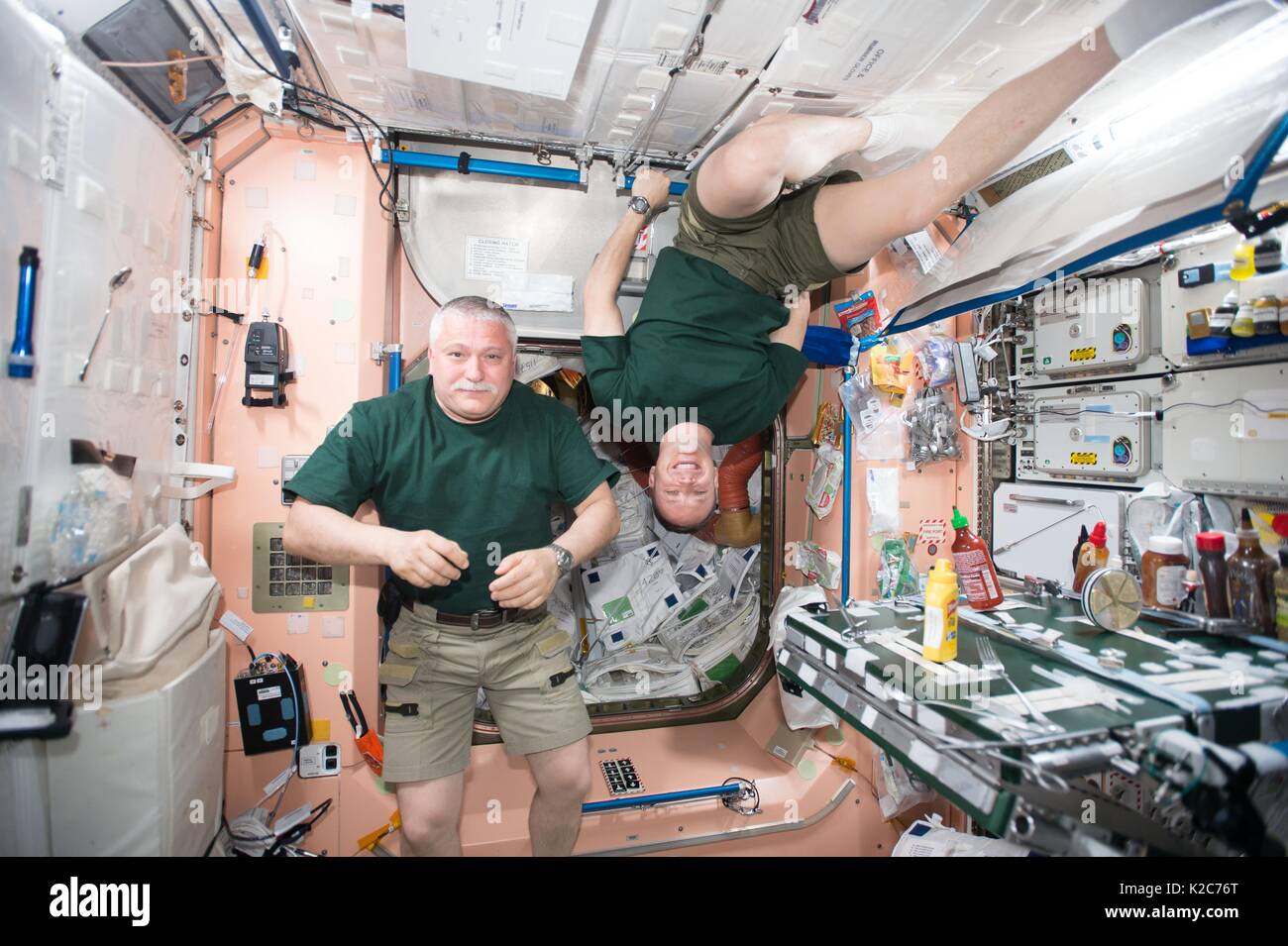 NASA International Space Station Expedition 51 prime crew members Russian cosmonaut Fyodor Yurchikhin of Roscosmos (left) and American astronaut Jack Fischer take a break in the Unity Module April 29, 2017 in Earth orbit. Stock Photo