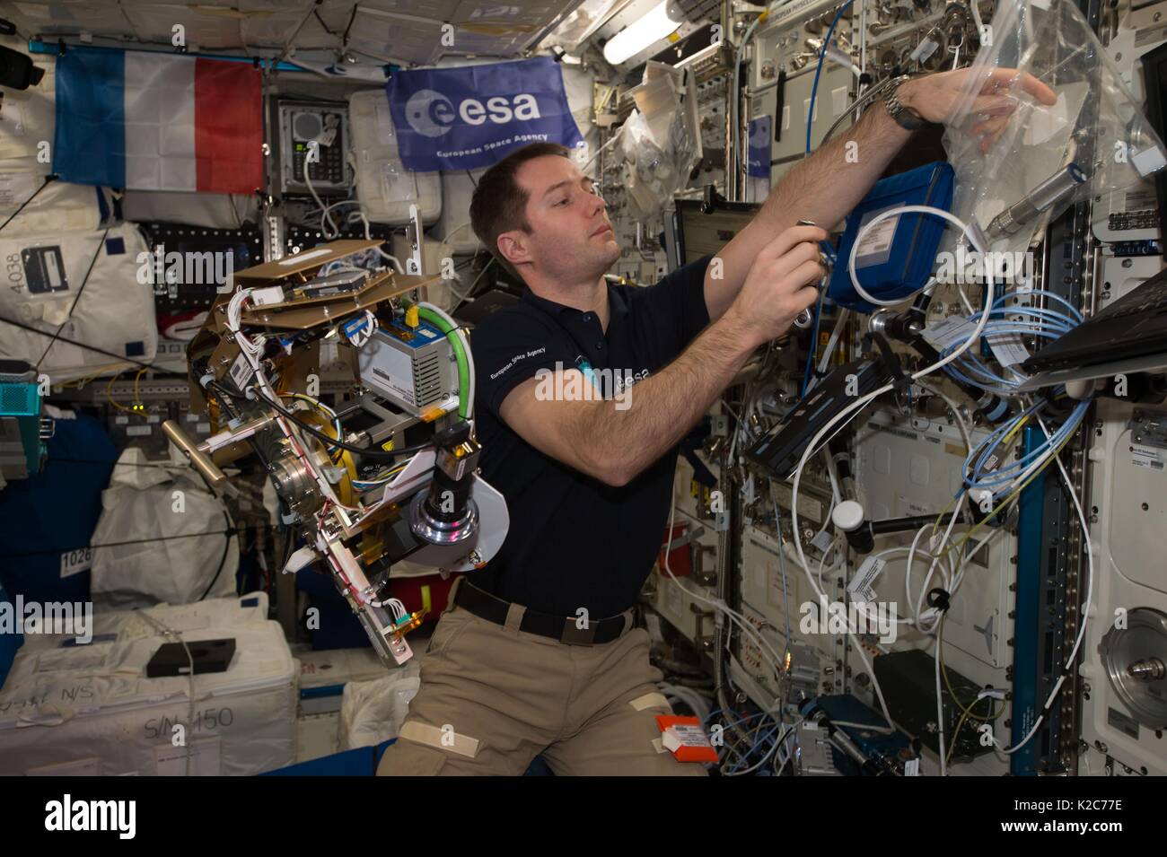 NASA International Space Station Expedition 51 prime crew member French astronaut Thomas Pesquet of the European Space Agency works inside the Columbus Laboratory Module May 2, 2017 in Earth orbit. Stock Photo