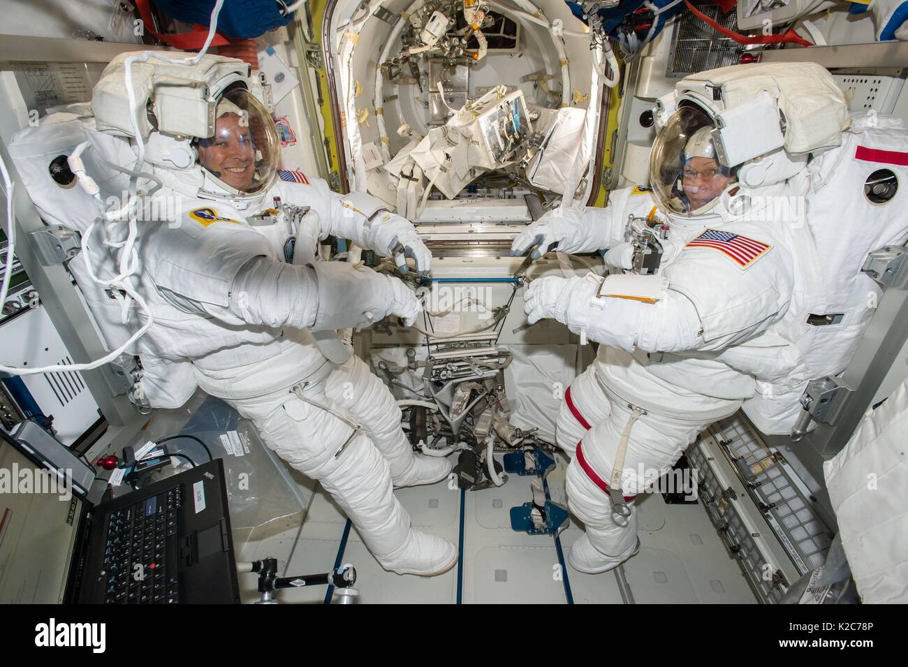 NASA International Space Station Expedition 51 prime crew members American astronauts Jack Fischer (left) and Peggy Whitson wear spacesuits in the Quest airlock in preparation for their EVA spacewalk May 12, 2017 in Earth orbit. Stock Photo