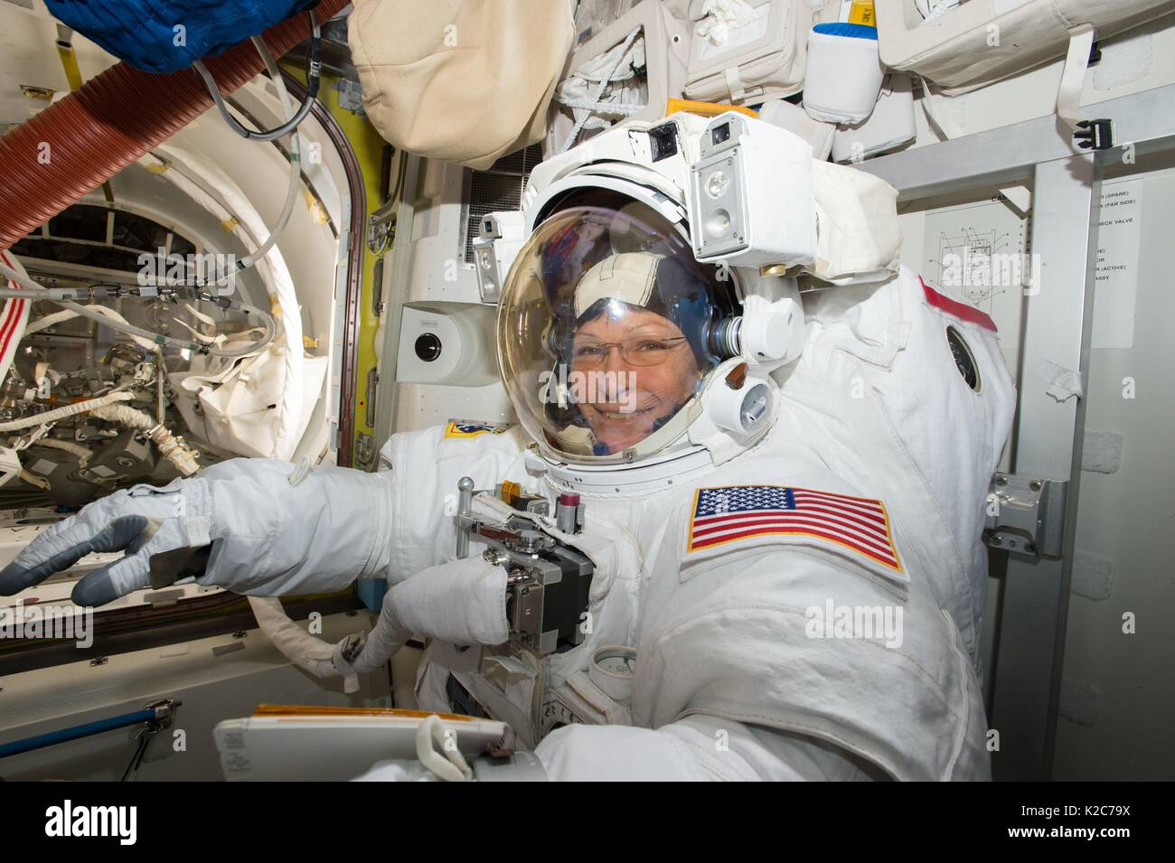 NASA International Space Station Expedition 51 prime crew member American astronaut Peggy Whitson suits up in a spacesuit in preparation for an EVA spacewalk in the ISS Quest airlock May 23, 2017 in Earth orbit. Stock Photo