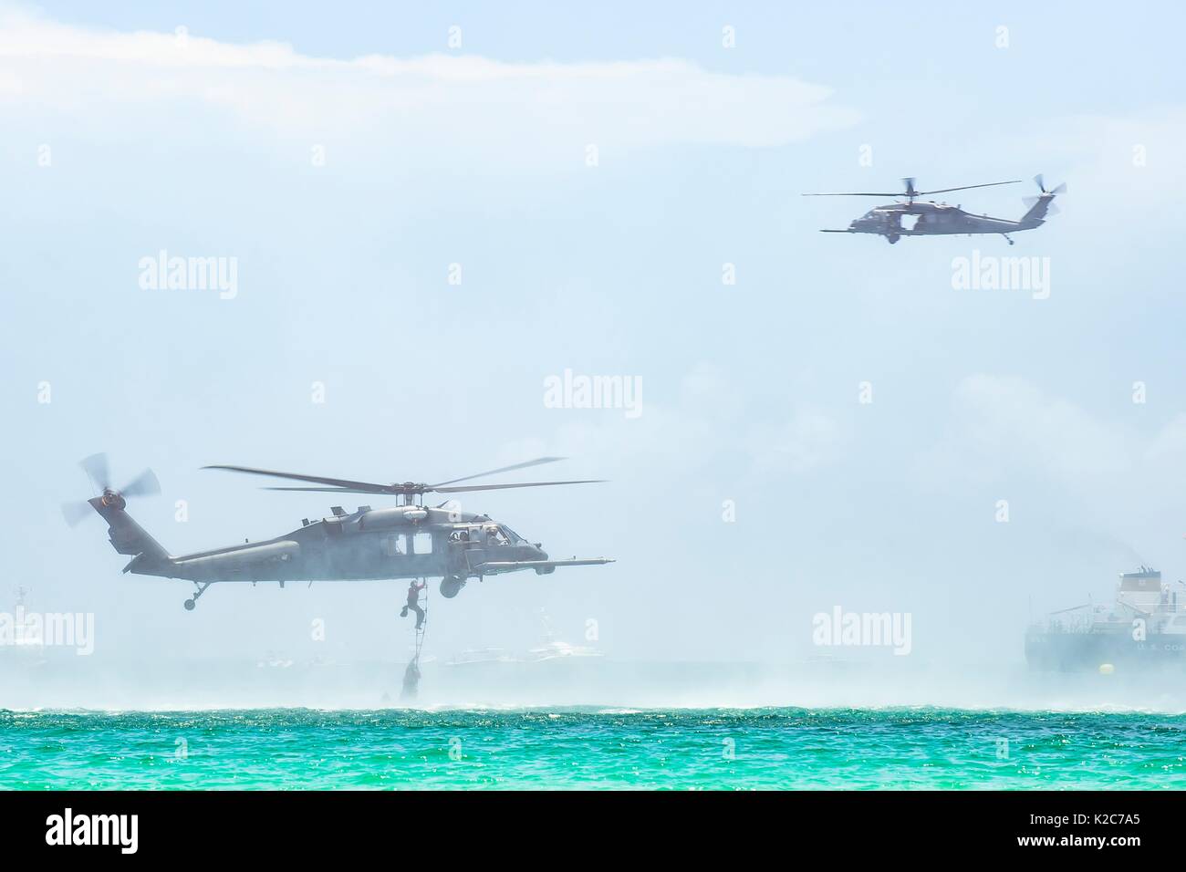 U.S. soldiers climb out of the water and into a U.S. Air Force HH-60G Pave Hawk helicopter during the National Salute to Americas Heroes Air and Sea Show May 27, 2017 in Miami Beach, Florida. Stock Photo