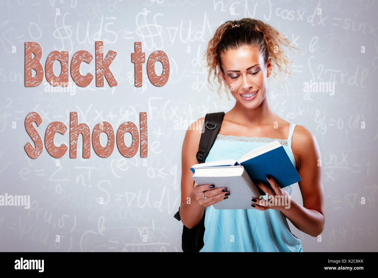 Beautiful smiling teenage girl with books and school bag Stock Photo ...