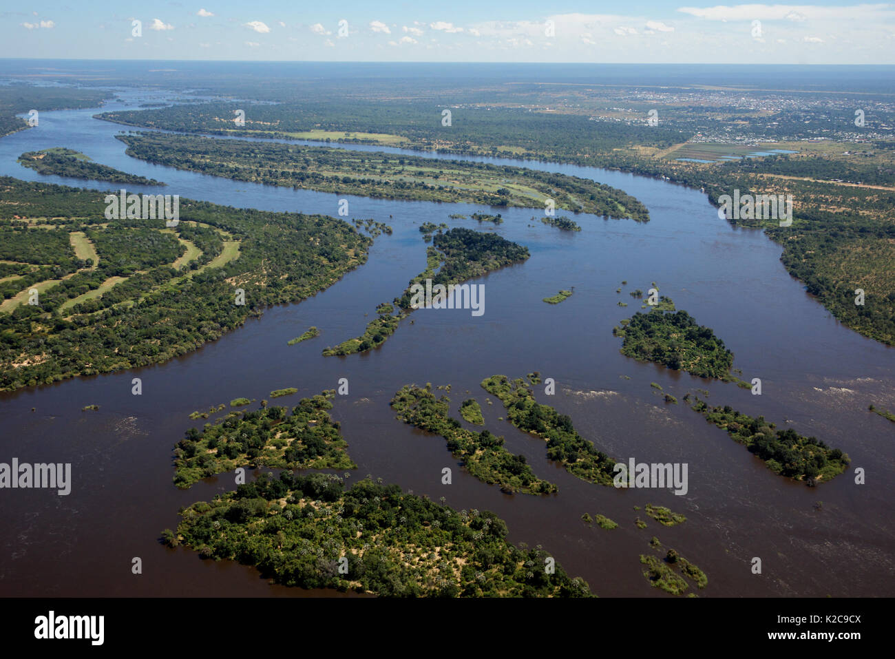 Aerial view Zambezi River with Elephant Hills golf course Zimbabwe on left and distant city of Livingstone Zambia on right Stock Photo