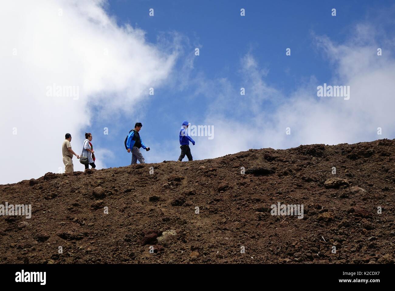 Hikers walking on the summit of Haleakala Stock Photo