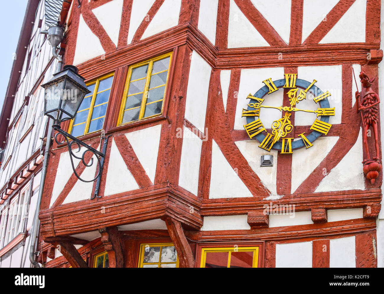 LIMBURG, GERMANY - MAY 11, 2017: Half-timbered house with clock and carved wooden figure in Limburg an der Lahn, Germany. The medieval city on the riv Stock Photo