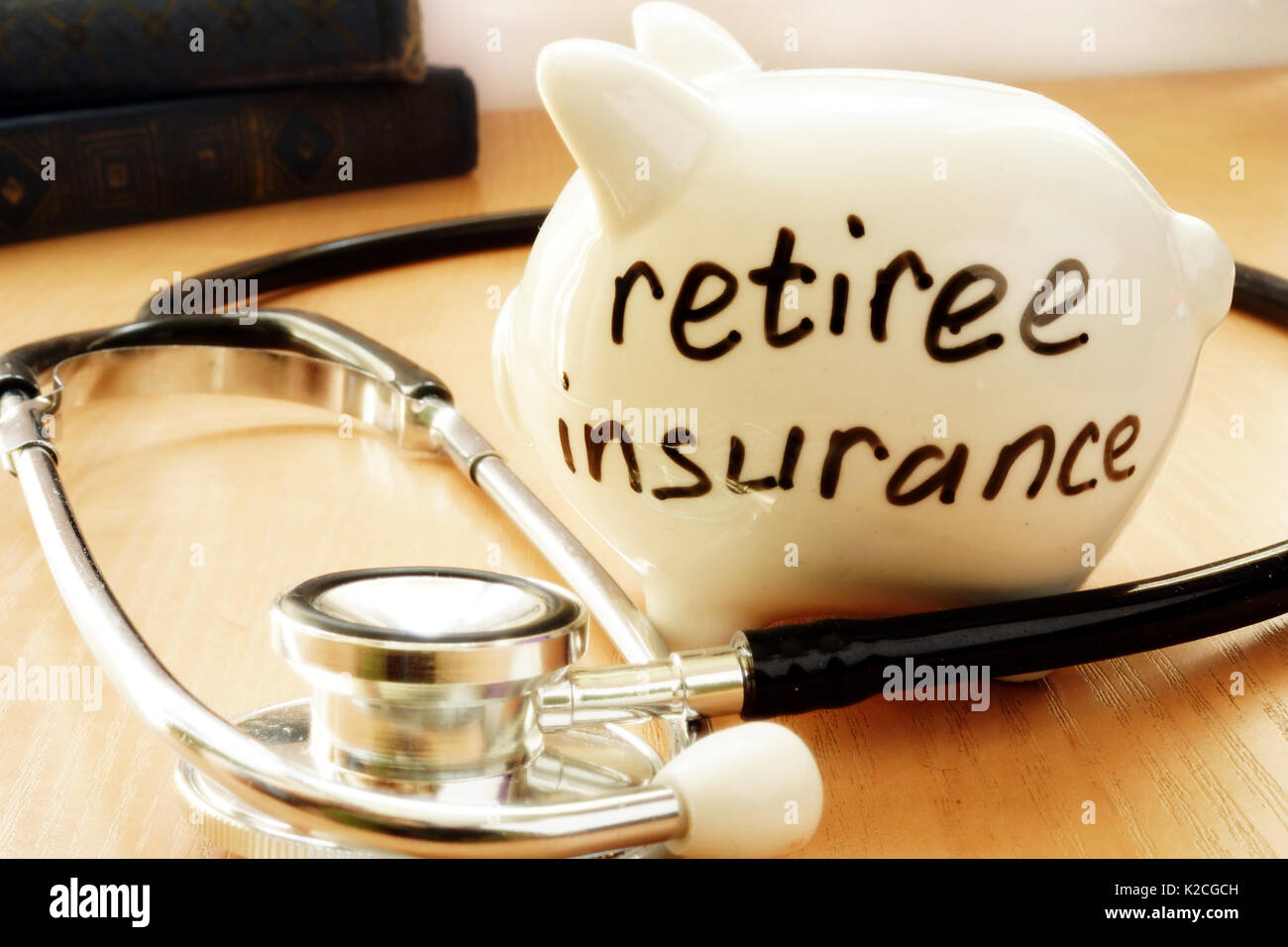 Piggy bank with words on a side retiree insurance. Stock Photo