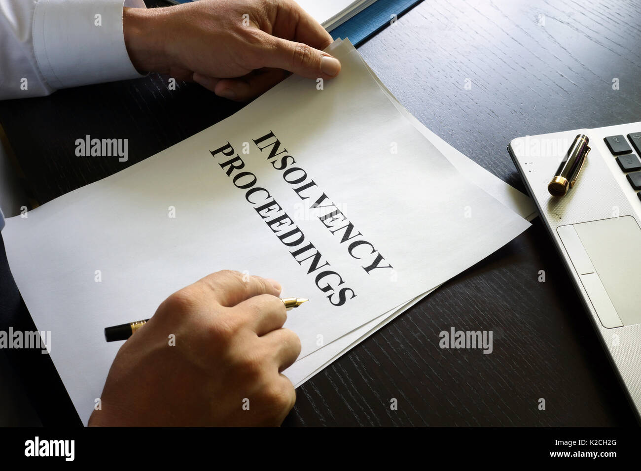 Document with title insolvency proceedings on a desk. Stock Photo