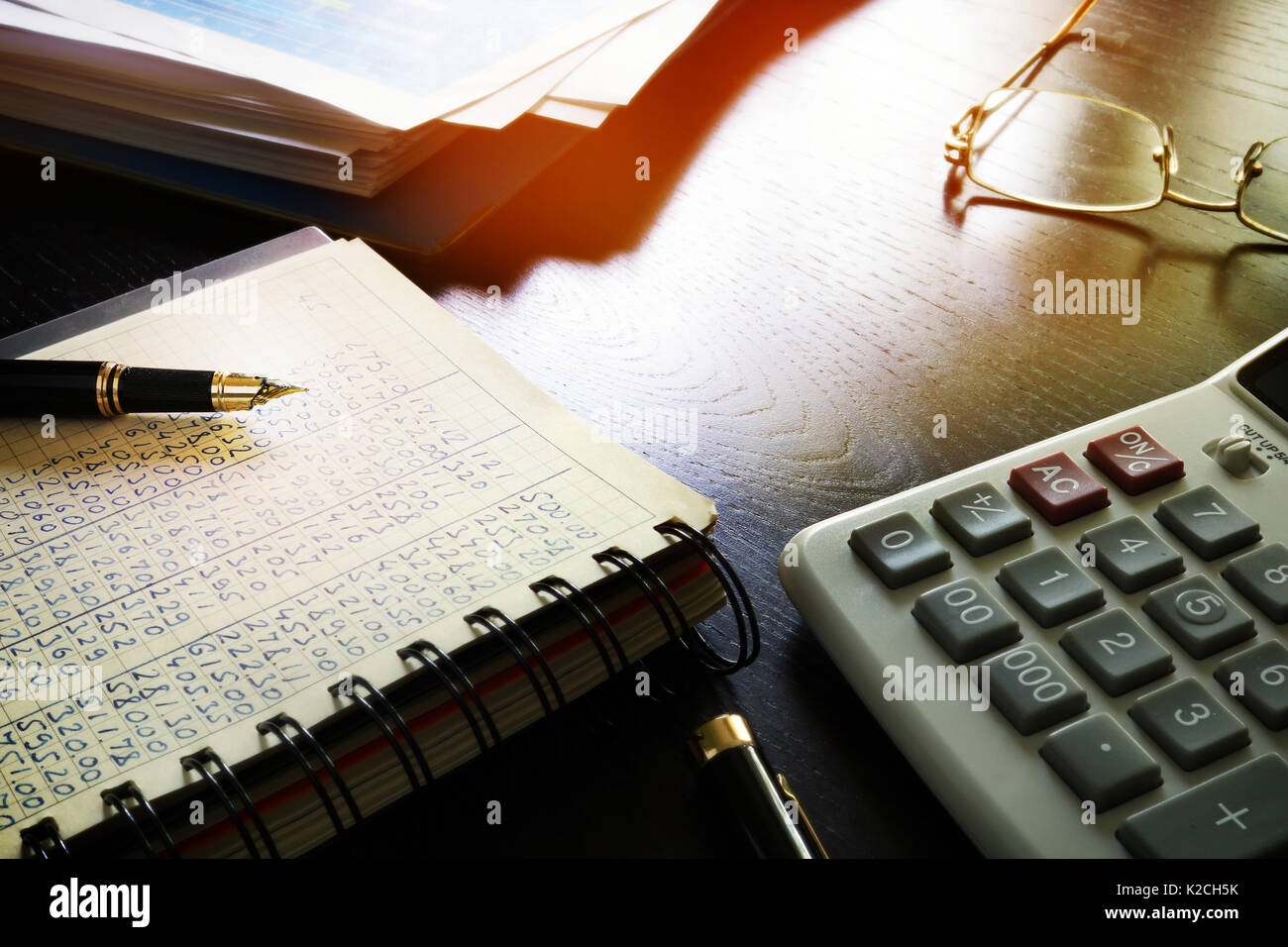 Office table with accounting book and financial report. Stock Photo