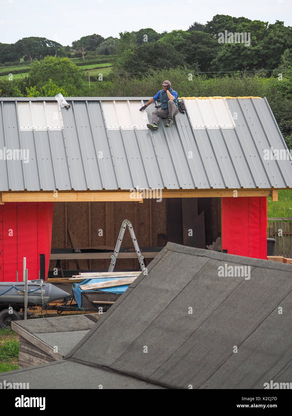 a builder roofer on steel roof construction working at height
