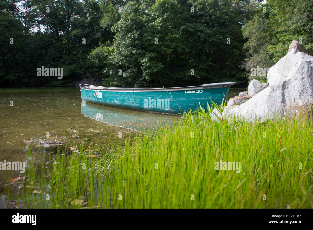 Canoe by the side of a lake in Upper Saddle River, New Jersey Stock
