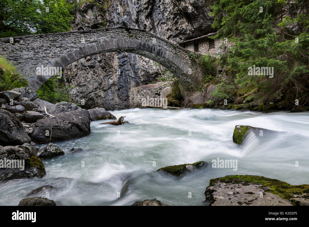 Ancient bridge over Verney Dora in Pre Saint Didier, Val d'Aosta, Italy Stock Photo