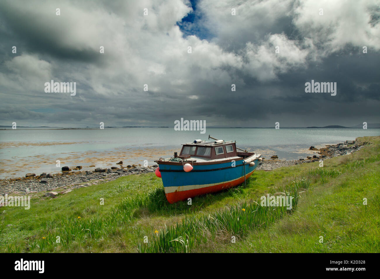 Old boat on shore of Bays Loch, Berneray, Hebrides, Scotland, UK, June. Stock Photo